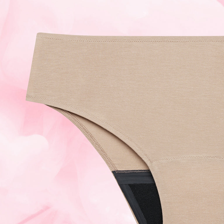 Gros plan sur la Culotte Menstruelle Confort Premium Brazilian Moderate, soulignant sa coupe haute et sa technologie TriTech pour une protection discrète et efficace.