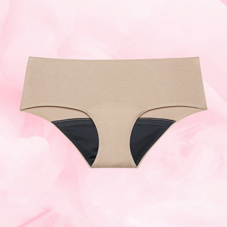 Confort Premium Hipster Light, culotte menstruelle beige et noire, taille basse, gousset multicouche TriTech Performance pour protection discrète et confort optimal pendant les règles.
