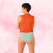 Femme portant la culotte menstruelle ComfortFit Essentielle Brazilian Moderate, vue de dos, mettant en valeur sa coupe taille haute et ajustement précis.