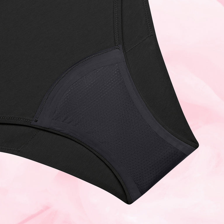 Culotte menstruelle noire ComfortFit Essentielle Brazilian Heavy, gros plan sur le tissu et les bords affûtés, offrant protection discrète et ajustement précis.