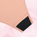 Culotte menstruelle ComfortFit Essentielle Brazilian Light, gros plan sur le tissu noir et rose avec coutures, conçue pour une protection discrète et fiable.