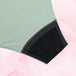Culotte menstruelle ComfortFit Essentielle Brazilian Moderate, gros plan sur la texture du tissu noir et gris, offrant protection fiable grâce à la technologie TriTech Performance.
