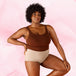 Culotte menstruelle Confort Premium High Waist Moderate, femme enceinte, coupe taille haute, main sur le ventre, souligne confort et discrétion.