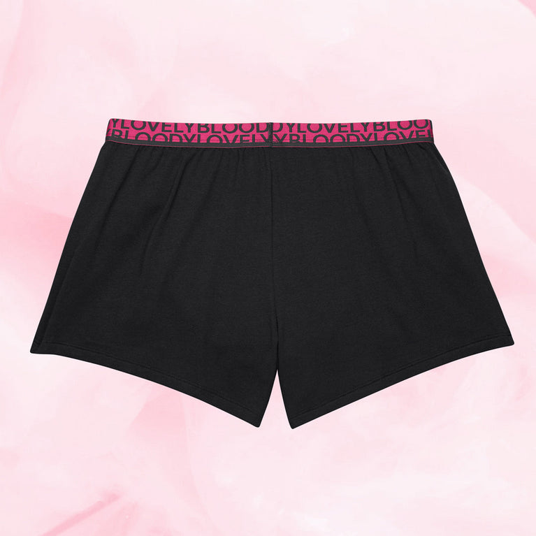 Short de Pyjama menstruel noir avec bande rose, conçu pour une protection nocturne optimale, offrant confort et sécurité sans fuites pendant le sommeil.