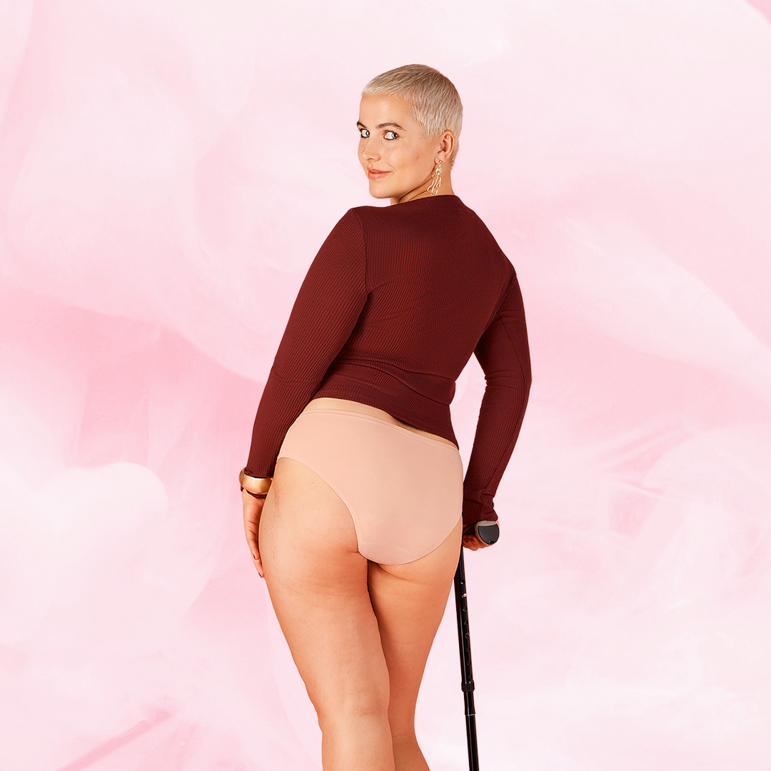 Une femme porte les culottes menstruelles ComfortFit Essentielle Brazilian Heavy, offrant protection discrète et ajustement taille haute pour confort et confiance pendant les règles.